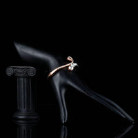 Side angle view of KHAISTA lightweight rose gold plated bangle