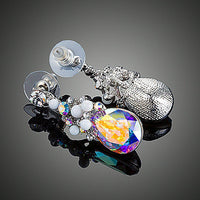Close up of KHAISTA large crystal drop earrings