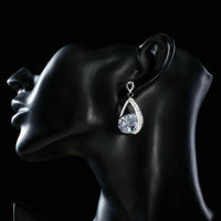 Side angle view of KHAISTA CZ drop earrings