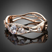 Close up detail of KHAISTA gold plated cubic zirconia bangle