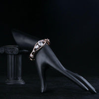Side angle view of KHAISTA gold plated cubic zirconia bangle