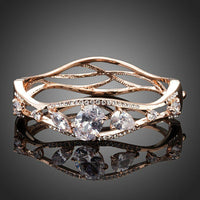 KHAISTA gold plated cubic zirconia bangle on white background