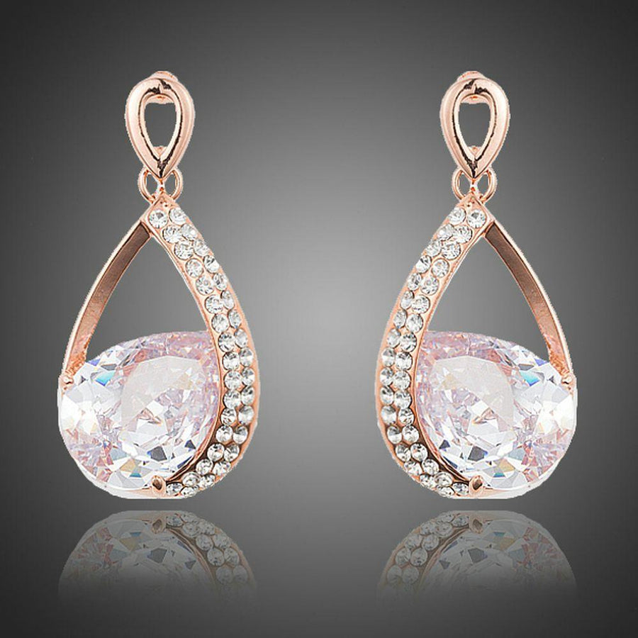 KHAISTA gold plated CZ drop earrings on white background