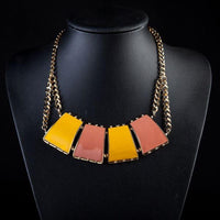 Side angle view of KHAISTA quadrilateral crystal pendant necklace