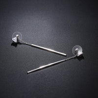 Side angle view of KHAISTA line triangle crystal drop earrings