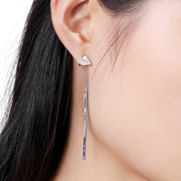 Close up of KHAISTA line triangle crystal drop earrings
