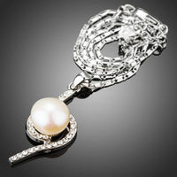 Side angle view of KHAISTA link chain flower pendant necklace