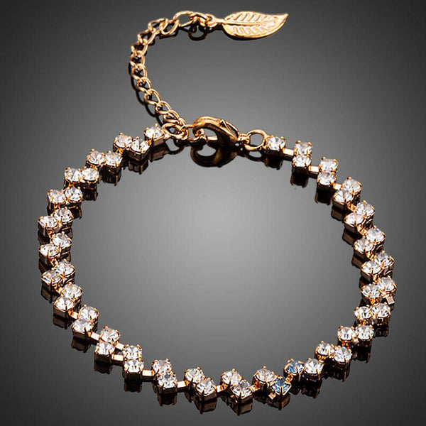 KHAISTA CZ leaf lobster clasp bracelet on white background