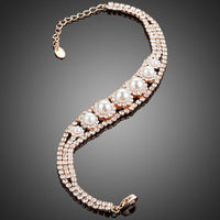 Close up detail of KHAISTA CZ pearl lobster clasp bracelet