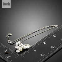 Pendant detail on KHAISTA long chain pearl pendant necklace