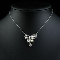 Close up detail of KHAISTA long chain pearl pendant necklace