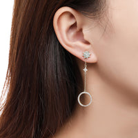 Side angle view of KHAISTA long chain round crystal drop earrings