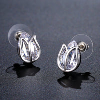 Side angle view of KHAISTA lotus crystal stud earrings