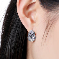 Close up of KHAISTA lotus crystal stud earrings