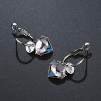 Side angle view of KHAISTA love crystal drop earrings