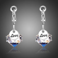 Close up of KHAISTA love crystal drop earrings
