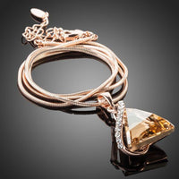 Close up detail of KHAISTA love triangle champagne crystal necklace