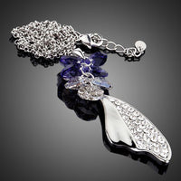Side angle view of KHAISTA crystal machete pendant necklace