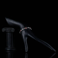 Side angle view of KHAISTA maroon CZ eye shape bracelet