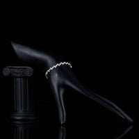 Side angle view of KHAISTA marquise cut CZ tennis bracelet