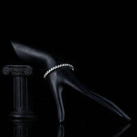 Side angle view of KHAISTA micro round CZ bezel bracelet
