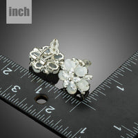 milky white CZ flower clip earrings detail view by KHAISTA
