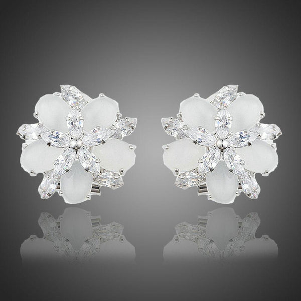 KHAISTA milky white CZ flower clip earrings on white background