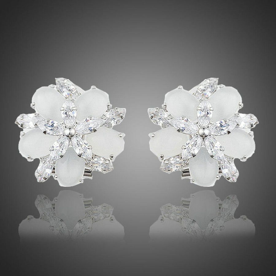 KHAISTA milky white CZ flower clip earrings on white background