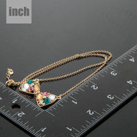 Pendant detail on KHAISTA multicolour crystal bow knot necklace