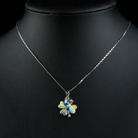Side angle view of KHAISTA multicolour flower heart pendant necklace