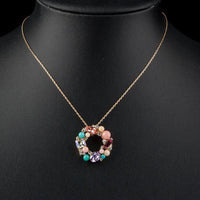 Side angle view of KHAISTA multicolour round crystal pendant necklace