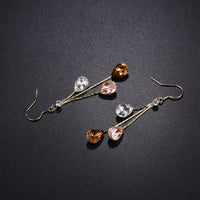 Close up of KHAISTA multicolour waterdrop dangle earrings