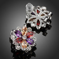 Close up of KHAISTA multicoloured flower stud earrings