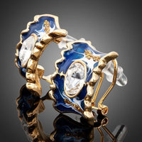 Close up of KHAISTA ocean blue crystal clip earrings