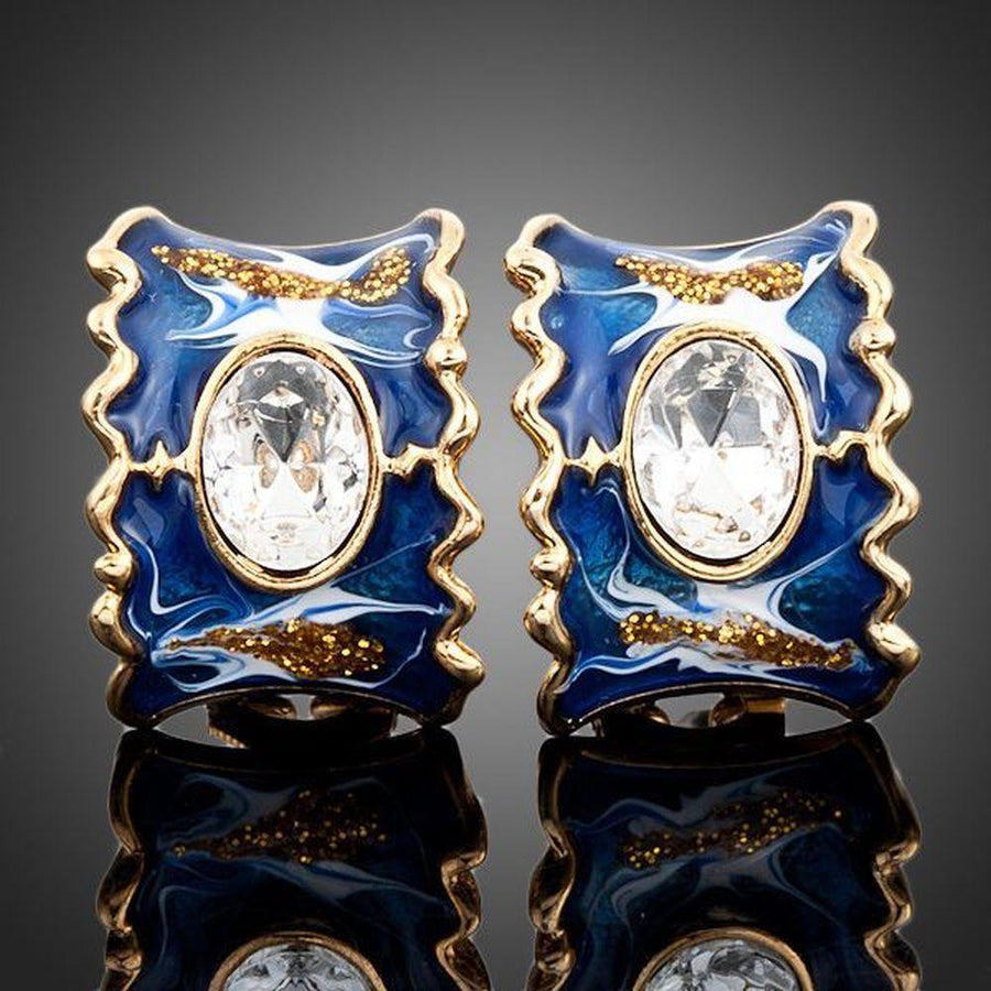 KHAISTA ocean blue crystal clip earrings on white background