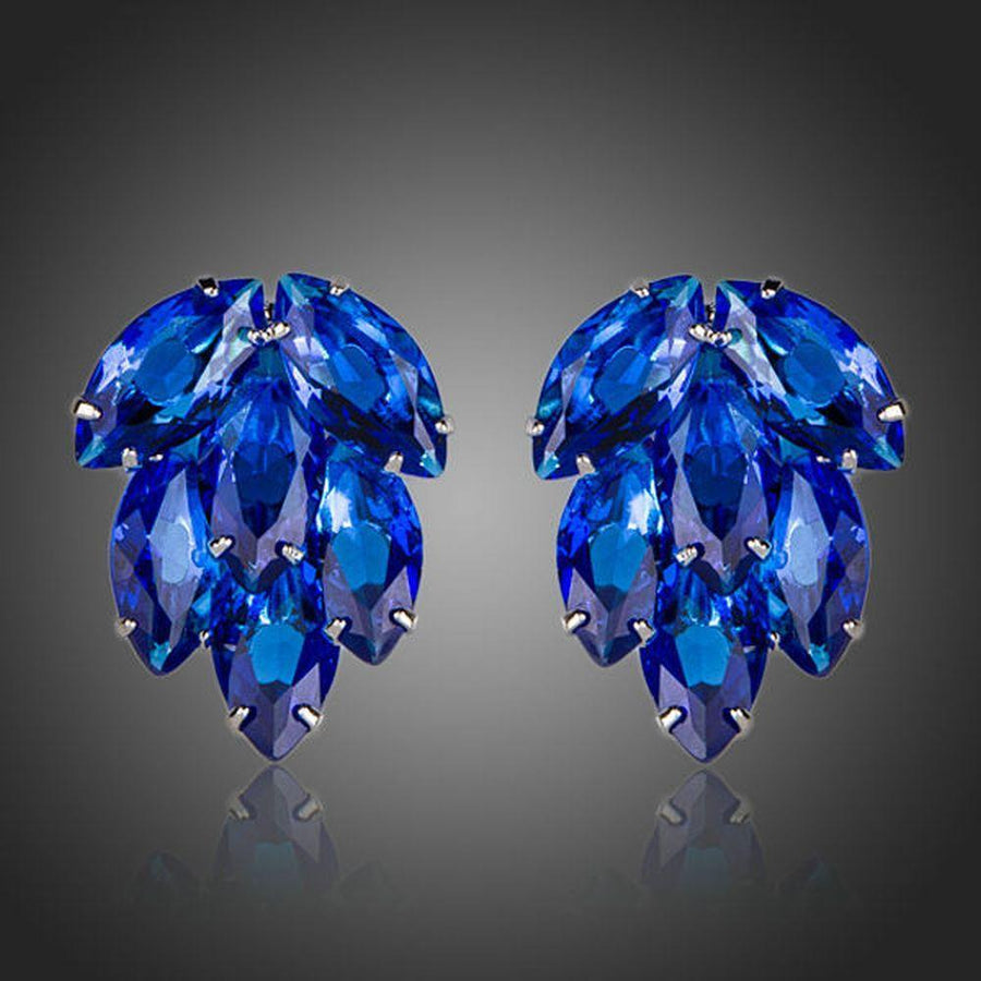 KHAISTA ocean blue CZ stud earrings on white background