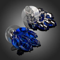 Close up of KHAISTA ocean blue CZ stud earrings