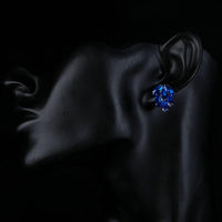 Side angle view of KHAISTA ocean blue CZ stud earrings