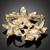 Close-up of oil paint on Khaista flower pin brooch