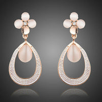 KHAISTA opal flower design drop earrings on white background