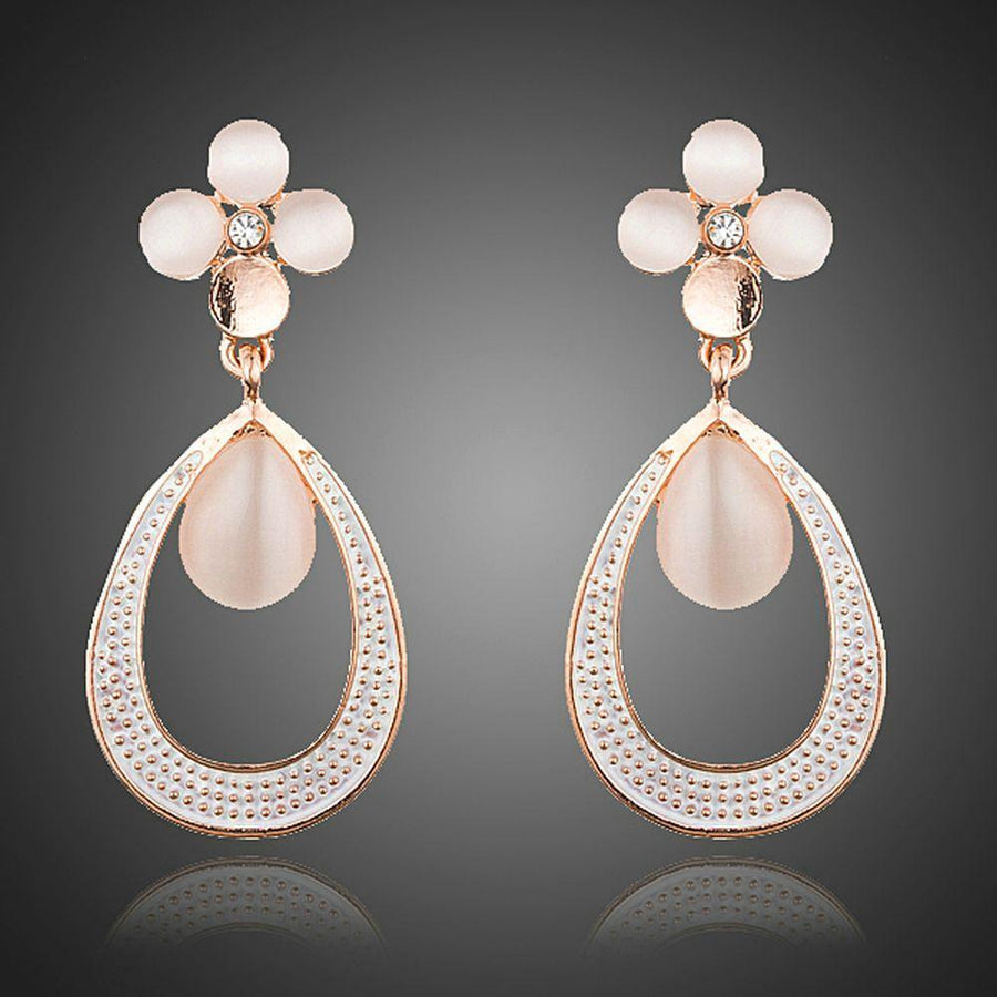 KHAISTA opal flower design drop earrings on white background