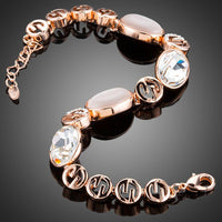 Close up detail of KHAISTA opal crystal lobster bracelet