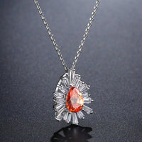 Pendant detail on KHAISTA orange CZ chain pendant necklace