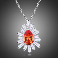 KHAISTA orange CZ chain pendant necklace on white background