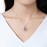 Side angle view of KHAISTA orange CZ chain pendant necklace