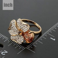 Artistic craftsmanship and structured profiles of the elegant orange flower crystal ring