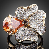 Detailed macro close up view of the brilliant stone settings on this premium orange flower crystal ring