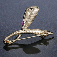 Side angle view of Khaista orange red leaf brooch