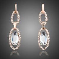 KHAISTA oval chain link crystal drop earrings on white background