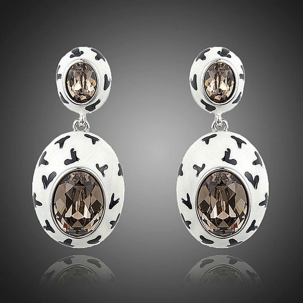 KHAISTA oval crystal pave drop earrings on white background